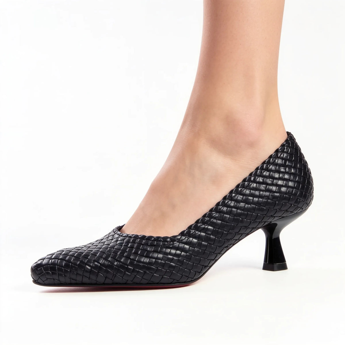 Black woven 5 cm heels worn with beige trousers