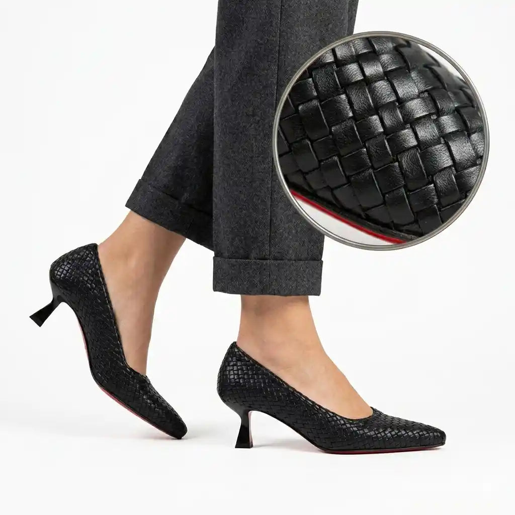 Black woven 5 cm heels worn on foot, with weave detail