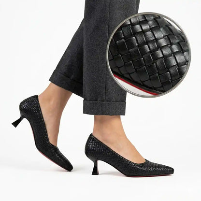 Black woven 5 cm heels worn on foot, with weave detail